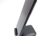 a cell phone on a stand on a white surface