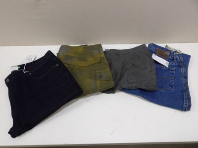 five pairs of men ' s jeans sitting on a white table