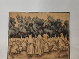 une vieille photo montrant un groupe de personnes assises dans un champ