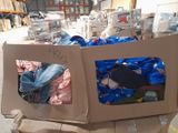 a cardboard box filled with clothes in a warehouse