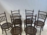 four chairs are lined up in a row on a white background