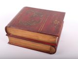 two old books stacked on top of each other