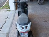 a motor scooter parked in front of a garage