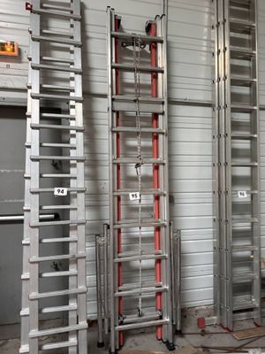 many ladders that are standing in a room