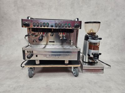 a close up of a coffee machine with a grinder on top of it