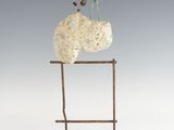 an image of a sculpture of a bird sitting on top of a rock