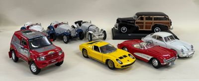 several toy cars are lined up in a row on a white surface