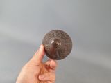 a person holding a metal object in their hand