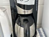 a coffee maker and a tea kettle on a kitchen counter
