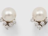 a pair of pearl and diamond earrings