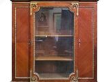 a wooden cabinet with a glass door on top of it