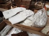 a box full of white gloves and other items in it