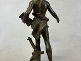 bronze statue of a man holding a book and a dog