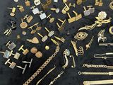 a lot of gold jewelry on display on a table