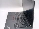 a black laptop with a red button on the keyboard