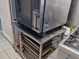 a microwave sitting on top of a metal shelf in a kitchen