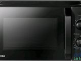 the microwave is black and has a timer on the front