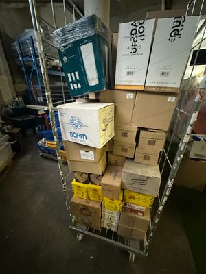 many boxes stacked on a cart in a warehouse