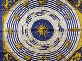 a blue and yellow scarf with a sun on it