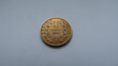 a gold coin on a white surface with a blue background
