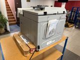 a printer sitting on top of a cart in a room
