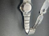 a close up of a watch on a black surface