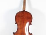 an old violin on a stand against a white background