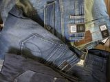 several pairs of jeans are stacked on top of each other in a box