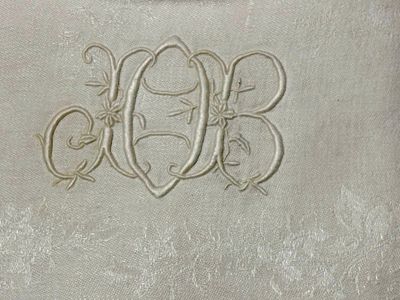 a white towel with a monogram on the front of it