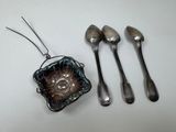 three spoons, a bowl, and a spoon rest on a table