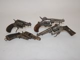 three old revolvers are sitting on a table with a white background