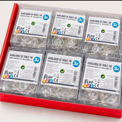 a red box filled with lots of different types of paper clips