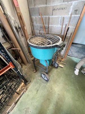 an image of a man working on a grill in a garage