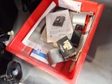 a red box filled with assorted items sitting on a table