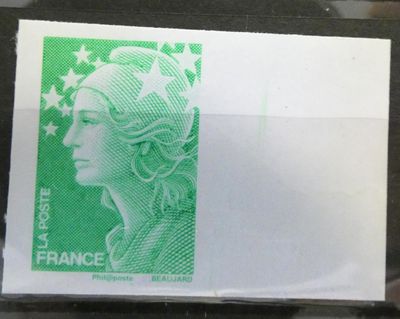 a green stamp with a woman ' s face on it