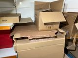 many boxes stacked on top of each other in a room