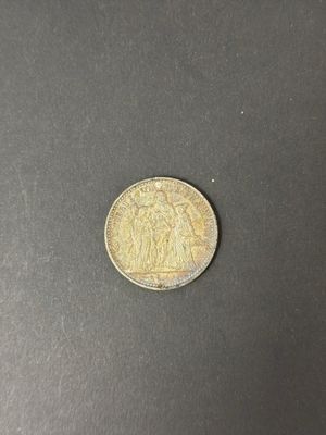 a close up of a coin on a black surface