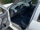 a silver car with its door open next to a white car