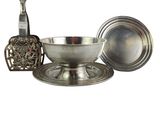 a silver plate with a spoon and a bowl on it