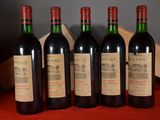 four bottles of wine are lined up on a table