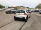 many cars parked in a parking lot near each other