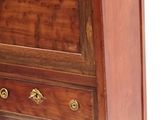 a small wooden cabinet with a drawer on top of it