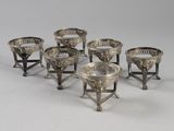 six silverplated cups and saucers on stands