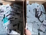 a box full of tickets and a person holding a pair of scissors