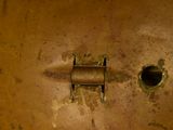 a rusted metal object with a hole in the middle