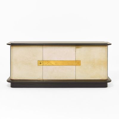 a white and black chest with a gold plated handle