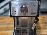 a small coffee maker sitting on a wooden table