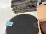 a box of sandpaper, a pair of shoes, and a pair of scissors on a table