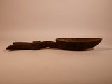 an old wooden spoon and a wooden spoon rest on a white surface