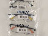 three pairs of glasses in plastic bags on a white surface